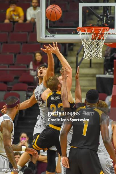 Texas A&M Aggie center Tyler Davis blocks a shot attempt by Northern Kentucky Norse forward Carson Williams during the basketball game between the...