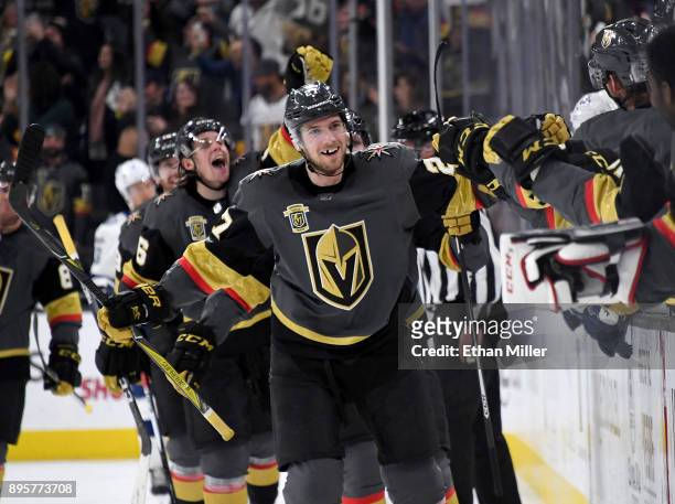 Shea Theodore of the Vegas Golden Knights celebrates with teammates after scoring on a power-play goal with 2.3 seconds left in the third period to...