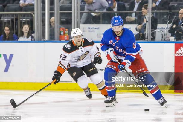 New York Rangers Defenseman Brendan Smith controls puck as Anaheim Ducks Right Wing Kevin Roy defends during the Anaheim Ducks and New York Rangers...