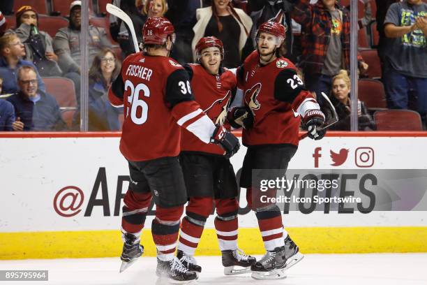 Arizona Coyotes right wing Christian Fischer , Arizona Coyotes center Clayton Keller , and Arizona Coyotes defenseman Oliver Ekman-Larsson celebrate...