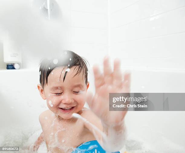 toddler boy in the bathtub - kids splashing stock pictures, royalty-free photos & images