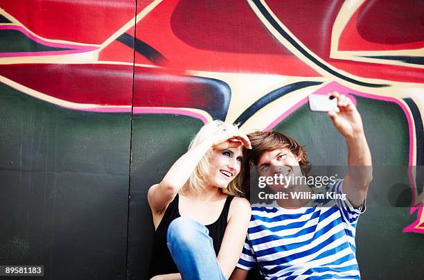 couple taking self portrait using mobile phone - bristol stock-fotos und bilder