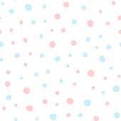Pink and blue round spots on white background. Cute seamless pattern. Irregular polka dots. Drawn by hand.