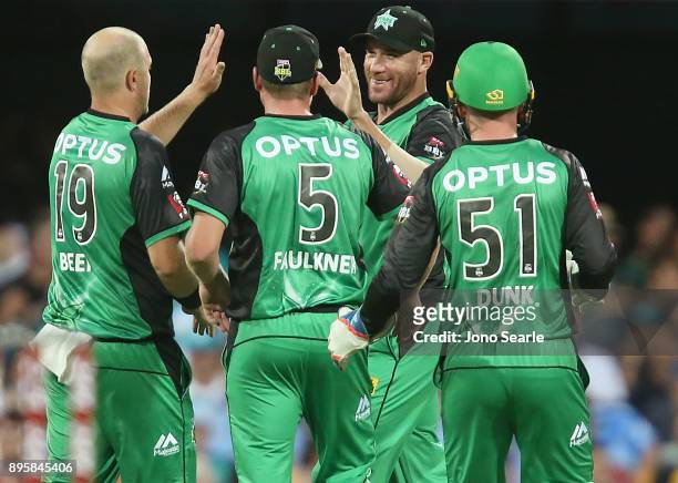 Melbourne Stars player John Hastings celebrates taking a catch with team mates during the Big Bash League match between the Brisbane Heat and the...