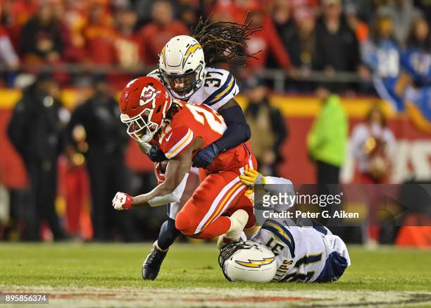 Strong safety Jahleel Addae and free safety Adrian Phillips of the Los Angeles Chargers tackle running back Kareem Hunt of the Kansas City Chiefs...