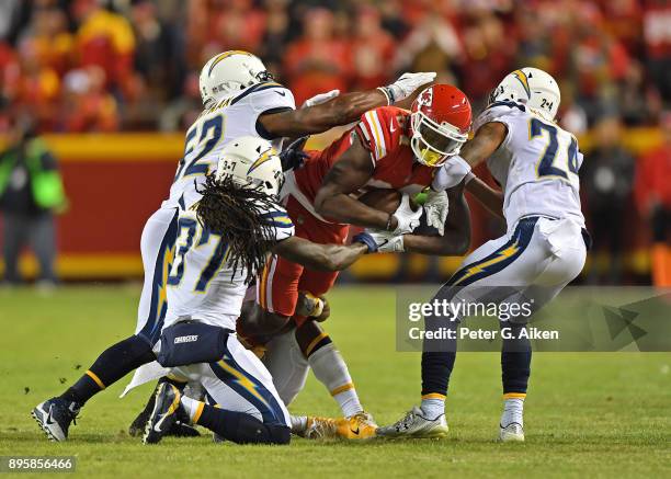 Tight end Demetrius Harris of the Kansas City Chiefs gets gang tackled by inside linebacker Denzel Perryman, strong safety Jahleel Addae and...