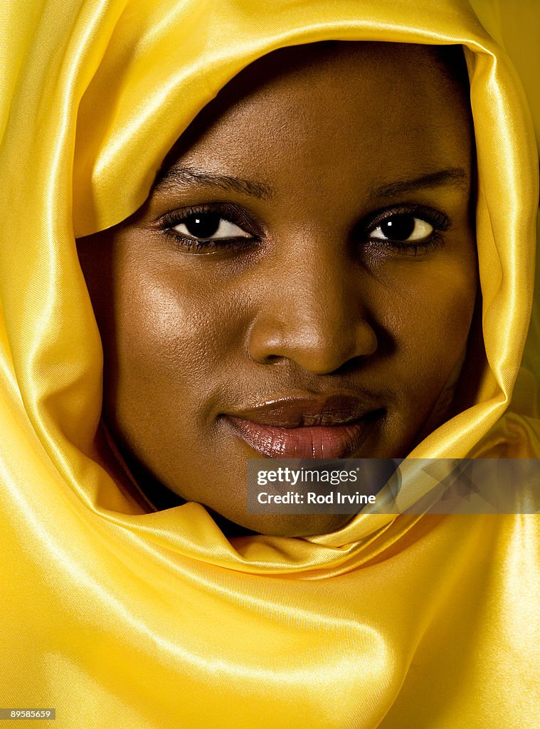 Headshot Of Woman Wearing Bright Yellow Headscarf