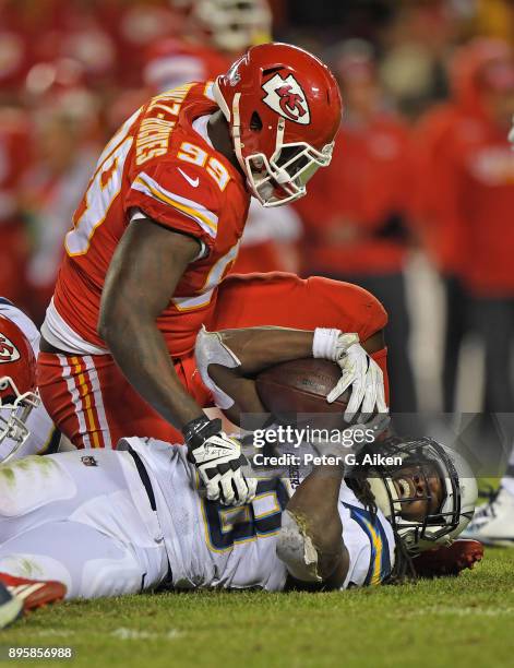 Defensive end Rakeem Nunez-Roches of the Kansas City Chiefs looks down at running back Melvin Gordon of the Los Angeles Chargers of the Los Angeles...