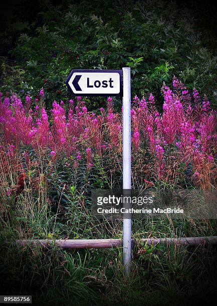 signpost to the village of lost - catherine macbride stock pictures, royalty-free photos & images