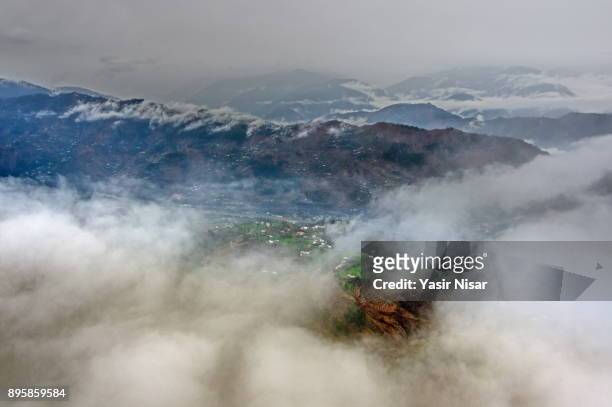 foggy misty landscape of kashmir after snowfall - yasir nisar stock-fotos und bilder