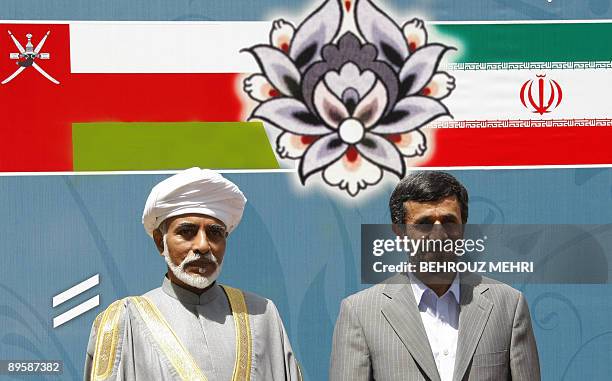 Iranian President Mahmoud Ahmadinejad welcomes Omani leader, Qaboos bin Said , at the presidential offices in Tehran on August 4, 2009. The sultan of...