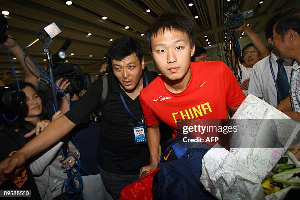 China's swimming sensation Zhang Lin arrives back from Rome after the swimming World Championships at Beijing's Capital International Airport on...