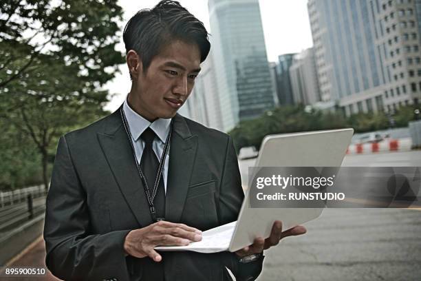 businessman using laptop outdoors - wap stock pictures, royalty-free photos & images