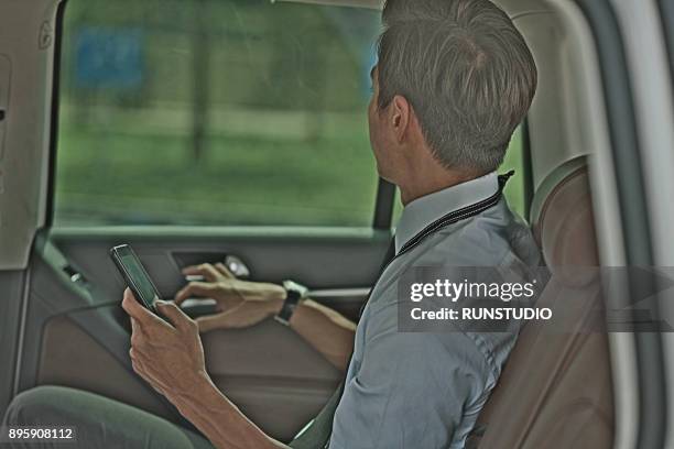 businessman in car with smartphone - wap stock pictures, royalty-free photos & images