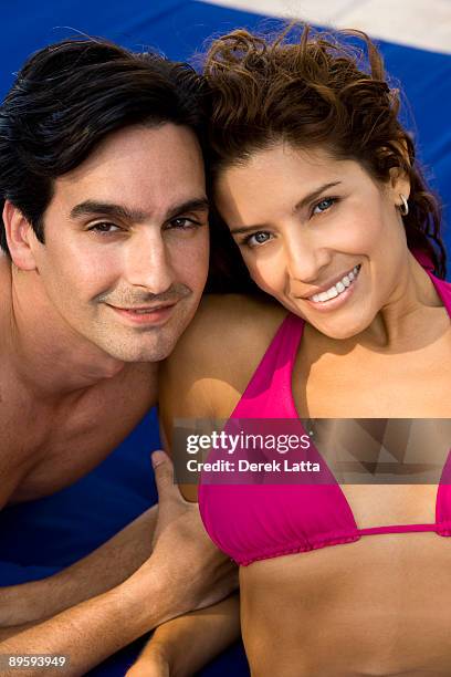 cu of young hispanic couple on a lounge chai - derek latta stock-fotos und bilder