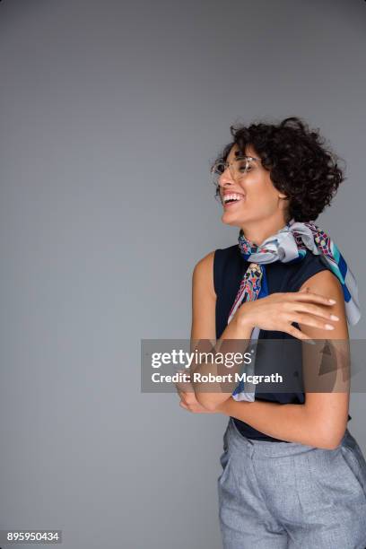 sophisticated women with coiffed frizzy hair and silk scarf that recalls a french look of the 60's - frizzy stock pictures, royalty-free photos & images