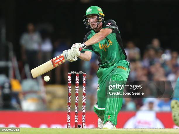 Melbourne Stars player James Faulkner hits the ball during the Big Bash League match between the Brisbane Heat and the Melbourne Stars at The Gabba...