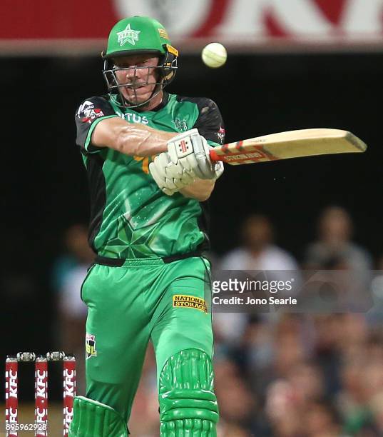 Melbourne Stars player James Faulkner hits the ball during the Big Bash League match between the Brisbane Heat and the Melbourne Stars at The Gabba...
