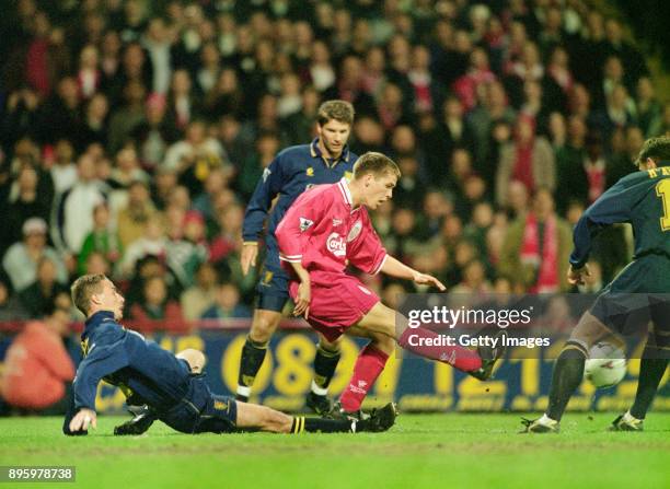 Year old Liverpool debutant Michael Owen is challenged by Chris Perry of Wimbledon during the FA Premier League match at Selhurst Park on May 6 Owen...