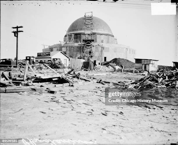 View of Adler Planetarium under construction in Chicago, Illinois, 1929. View looking east. Piles of wood and dirt, two small wooden structures, a...