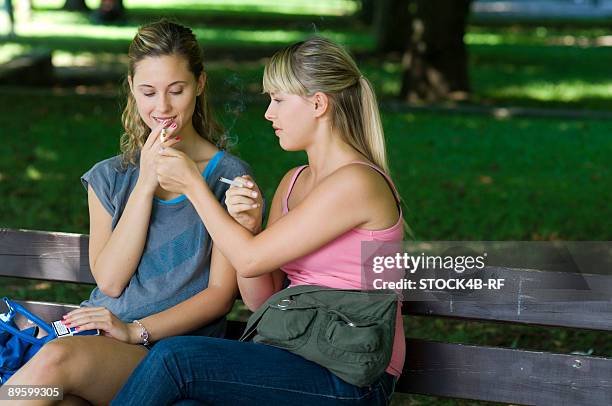 two young women smoking - girl smoking stock-fotos und bilder