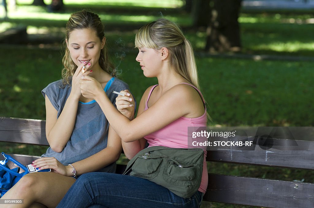 Two young women smoking