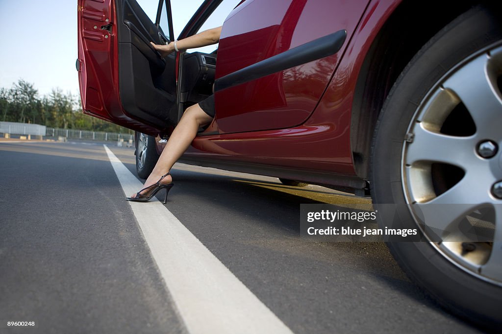 Woman stepping from drivers seat