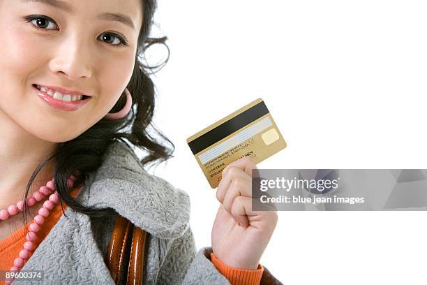 young woman with a credit card - earring card stock pictures, royalty-free photos & images