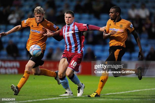 Gary Hooper of Scunthorpe battles for the ball with Richard Stearman and Ronald Zubar of Wolves during the Pre Season Friendly between Scunthorpe...