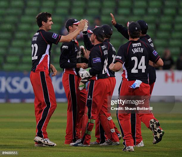 Kyle Hogg of Lancashire is congratulated by team mates after taking a wicket during the NatWest Pro40 Division Two match between Northamptoshire and...