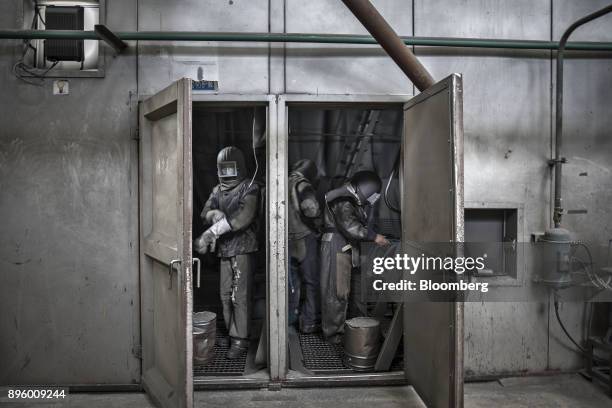 Bloomberg Best of the Year 2017: Workers wear protective clothing before entering a sand blasting chamber at the Singamas Container Holdings Ltd....