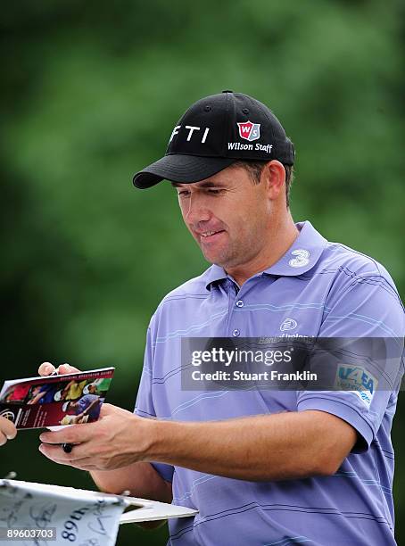 Padraig Harrington of Ireland signs autographs during a practice round of the World Golf Championship Bridgestone Invitational on August 4, 2009 at...