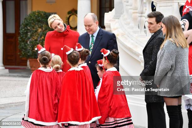 Princess Charlene of Monaco, Prince Albert II of Monaco, Louis Ducruet and Camille Gottlieb attend the Christmas Gifts Distribution on December 20,...