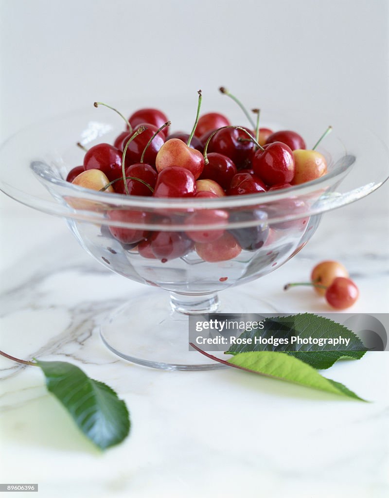 Fresh cherries in glass bowl