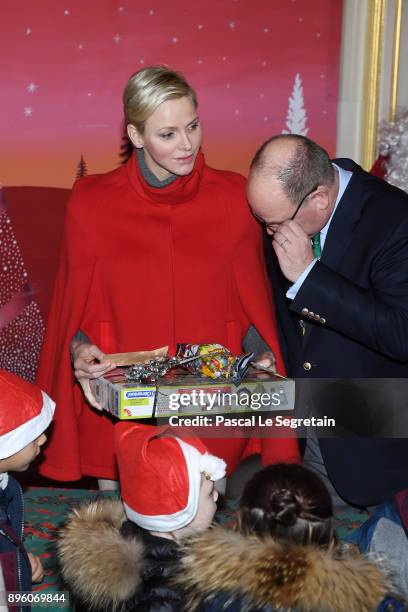 Princess Charlene of Monaco and Prince Albert II of Monaco attend the Christmas Gifts Distribution on December 20, 2017 in Monaco, Monaco.