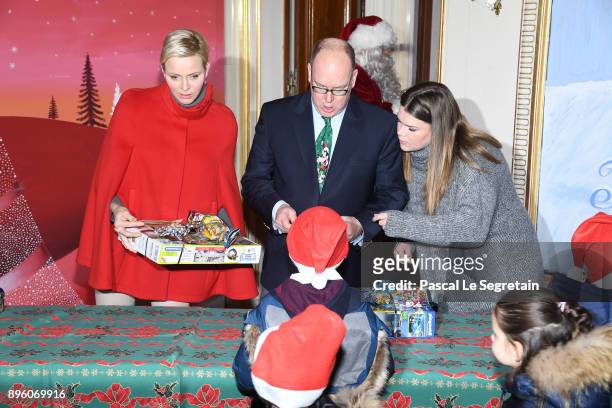 Princess Charlene of Monaco, Prince Albert II of Monaco and Camille Gottlieb attend the Christmas Gifts Distribution on December 20, 2017 in Monaco,...