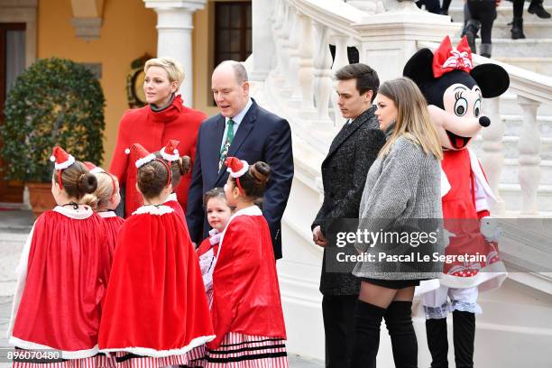 Princess Charlene of Monaco, Prince Albert II of Monaco, Louis Ducruet and Camille Gottlieb attend the Christmas Gifts Distribution on December 20,...