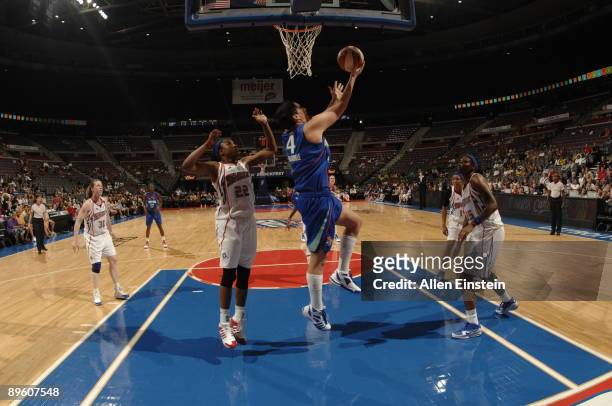 Janel McCarville of the New York Liberty puts up a reverse layup against Alexis Hornbuckle of the Detroit Shock on August 4, 2009 at The Palace of...