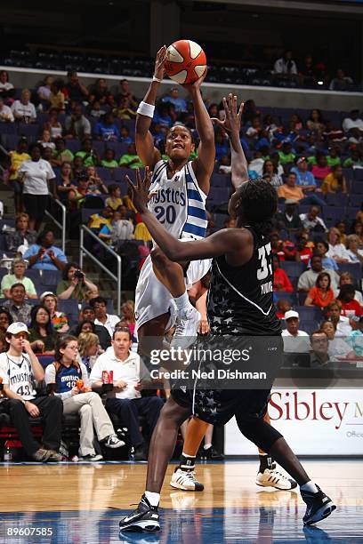 Alana Beard of the Washington Mystics shoots against Sophia Young of the San Antonio Silver Stars during the game at the Verizon Center on July 15,...