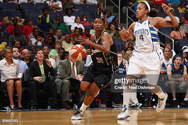 Vickie Johnson of the San Antonio Silver Stars drives around Marissa Coleman of the Washington Mystics during the game at the Verizon Center on July...