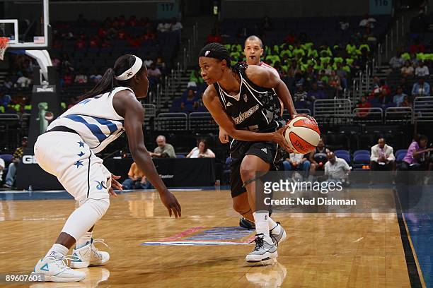 Vickie Johnson of the San Antonio Silver Stars looks to move the ball against Matee Ajavon of the Washington Mystics during the game at the Verizon...