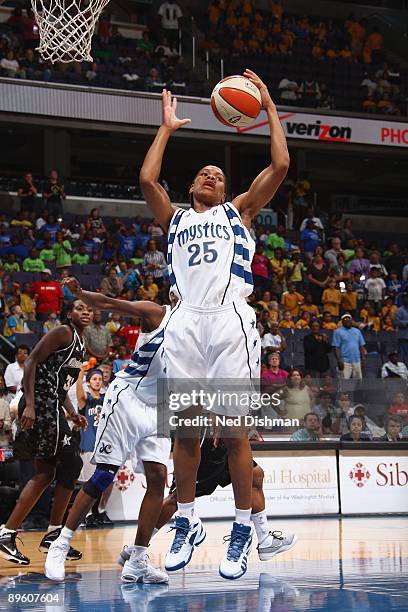 Monique Currie of the Washington Mystics hauls in a rebound against the San Antonio Silver Stars during the game at the Verizon Center on July 15,...