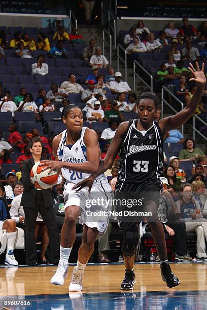 Alana Beard of the Washington Mystics drives to the basket against Sophia Young of the San Antonio Silver Stars during the game at the Verizon Center...