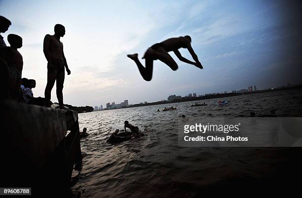 Man plunges into the East Lake for a swim on August 4, 2009 in Wuhan of Hubei Province, China. Wuhan, one of the "Three Furnaces" in China, is known...