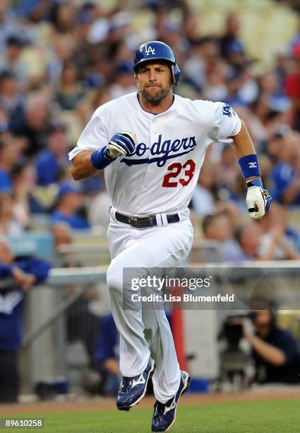 Casey Blake of the Los Angeles Dodgers runs home to score in the first inning against the Milwaukee Brewers at Dodger Stadium on August 4, 2009 in...