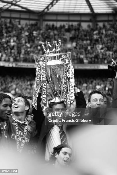 Chelsea players Didier Drogba, Frank Lampard, manager Jose Mourinho and John Terry celebrate with the league trophy as they celebrate winning the...