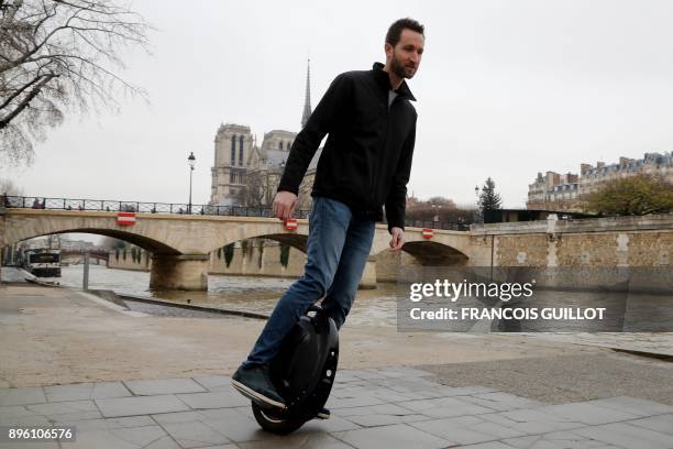 Man uses a monowheel to make his way on December 20, 2017 in Paris.