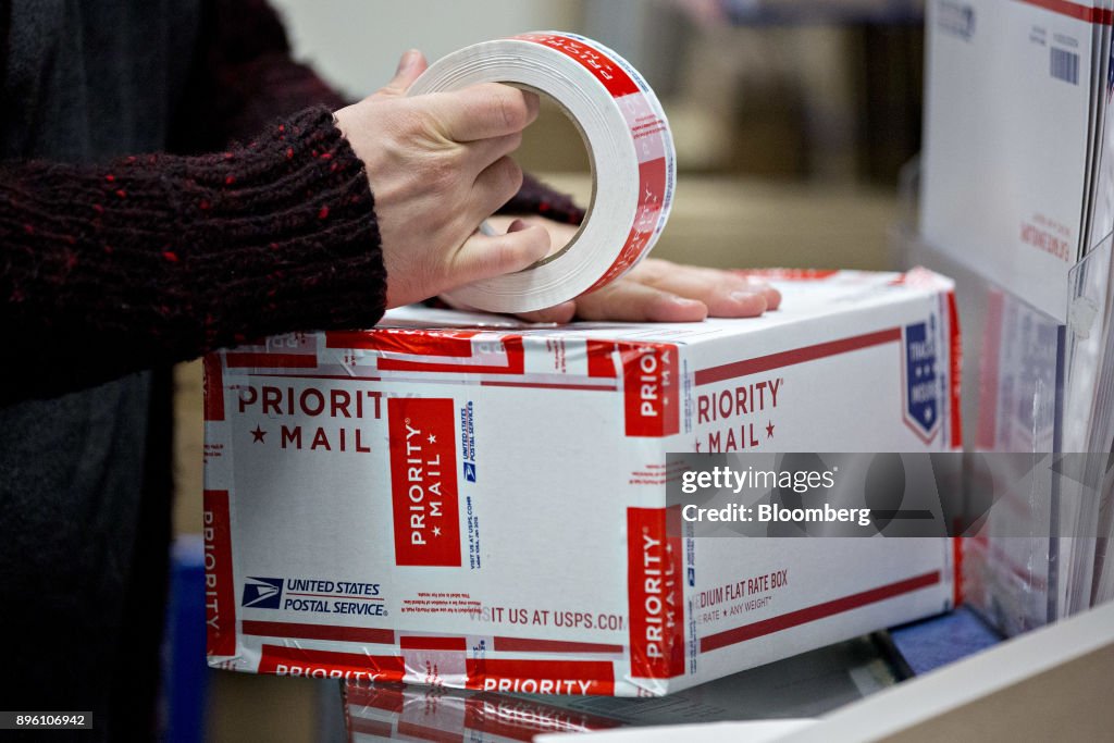 Usps Red Line Process A customer wraps a United States Postal Service priority mail package ...