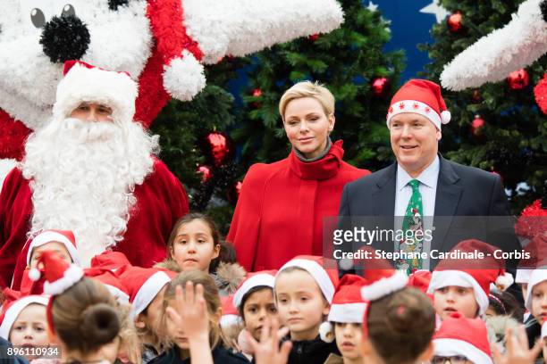 Princess Charlene of Monaco and Prince Albert II of Monaco attend the Christmas Gifts Distribution on December 20, 2017 in Monaco, Monaco.