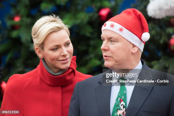 Princess Charlene of Monaco and Prince Albert II of Monaco attend the Christmas Gifts Distribution on December 20, 2017 in Monaco, Monaco.